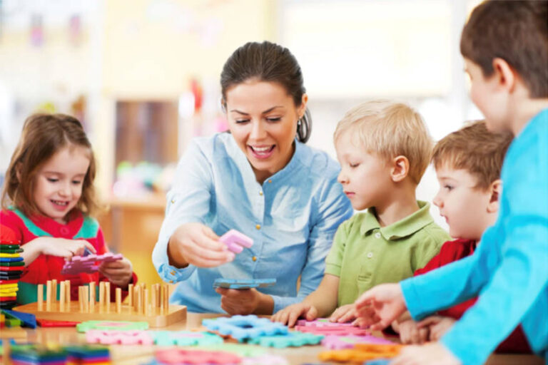 A woman with children at a table with jigsaw puzzle pieces
