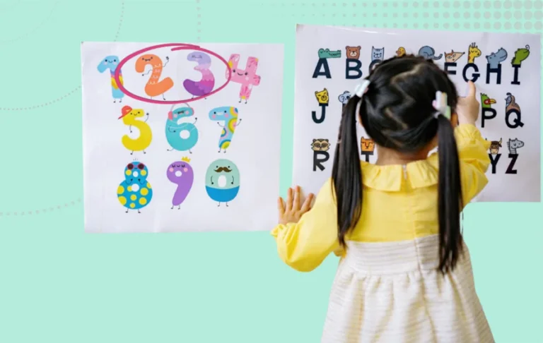 23 Ofsted key questions - girl pointing at alphabet alongside a number chart with 2 and 3 circled