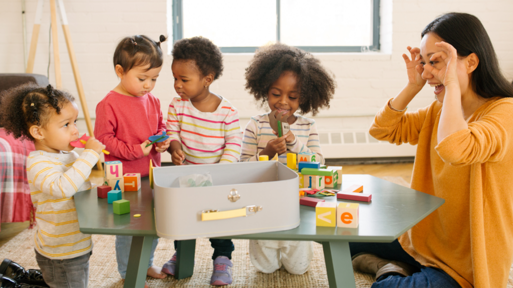 teacher playing with preschool children