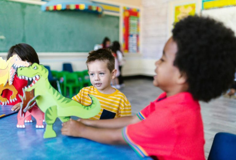 EYFS-Dinosaurs-image-Children-playing-with-cardboard-dinosaurs