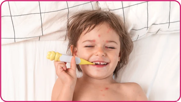 Hand foot and mouth image - smiling child with spots taking temperature