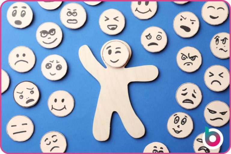 Self-regulation-image-A-wooden-cutout-of-a-person-with-an-interchangeable-face-surrounded-by-faces