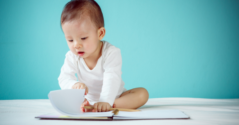 baby writing in a book