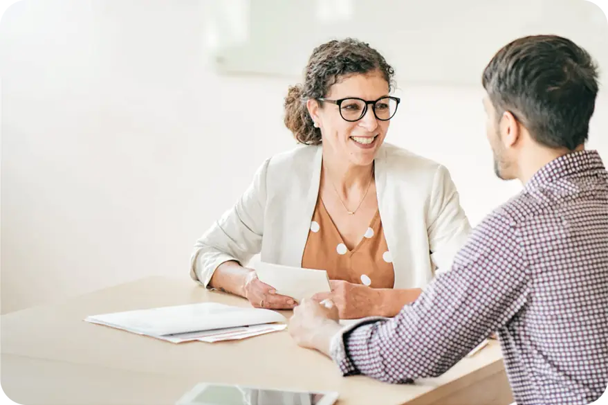 Adults talking over a table with documents