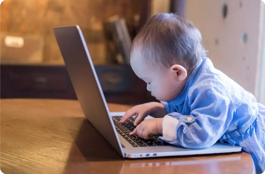 A baby or toddler 'using' a laptop