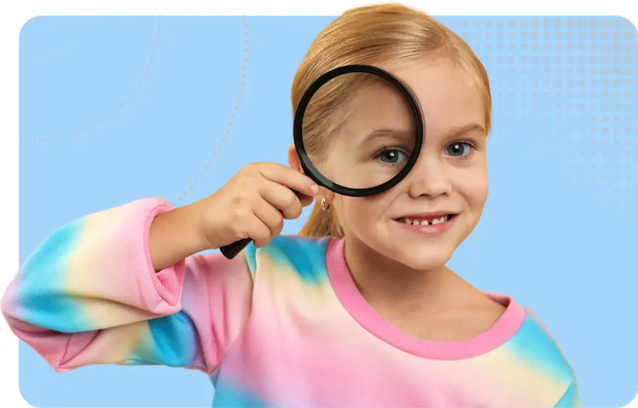 ofsted curriculum image - child with a magnifying glass held over their eye