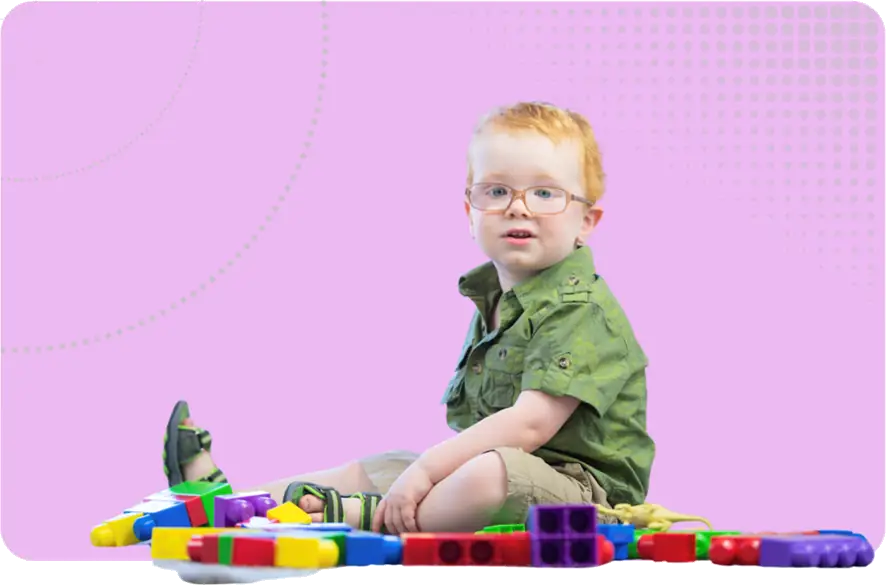 Safeguarding Children Image - A child sat on his own surrounded by blocks