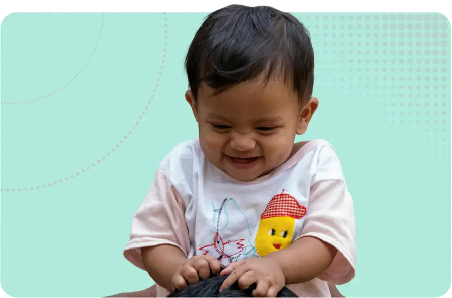 Safeguarding Children Image - A happy child sat on someone's shoulders (out of frame)