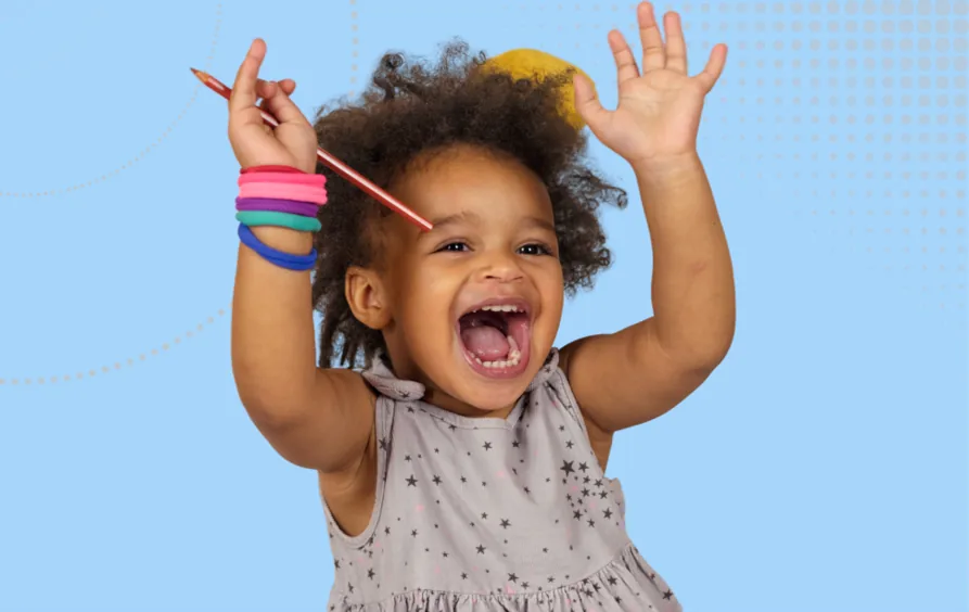 How Ofsted Inspects achievement image - A very happy child holding a pencil