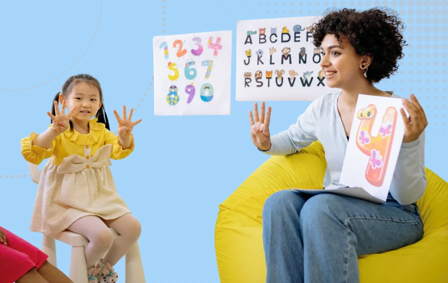 EYFS Ofsted Inclusion Questions Image - Child and practitioner learning the number 4. The girl is technically showing 8
