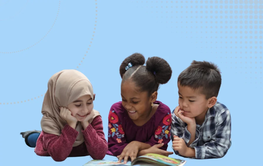 Inclusion outcomes inclusive nurseries image - children reading lying on the floor with one book between them